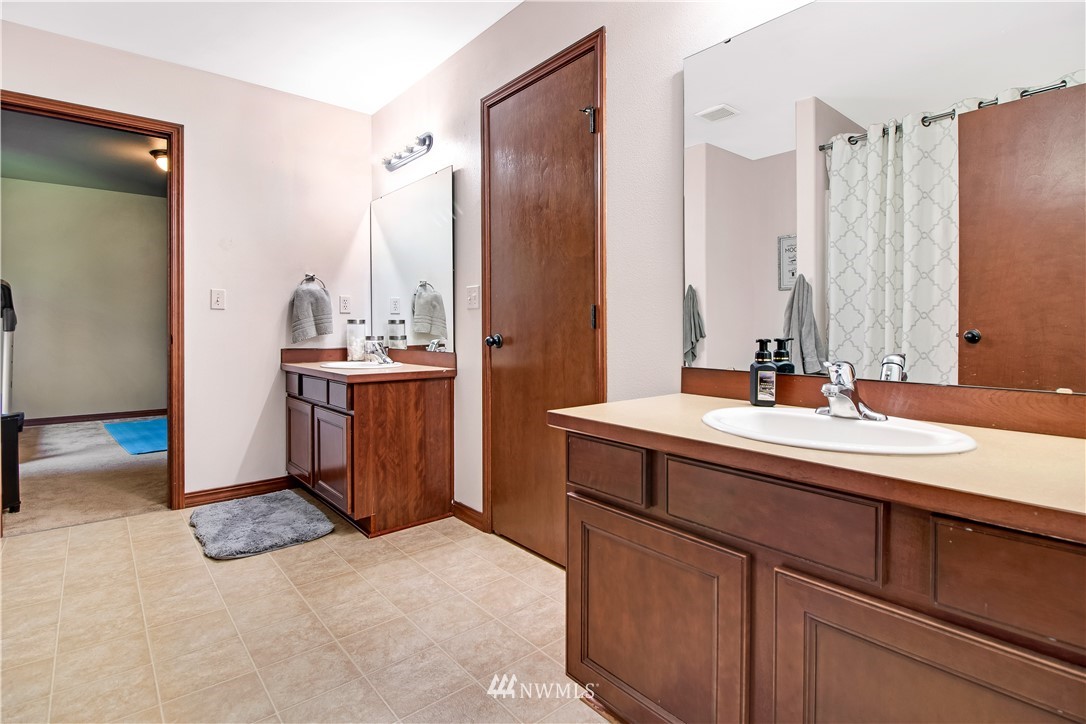 16704 Sargent Road Southwest Rochester, WA 98579 - Photo 27 of 40 a bathroom with a sink double vanity and a mirror