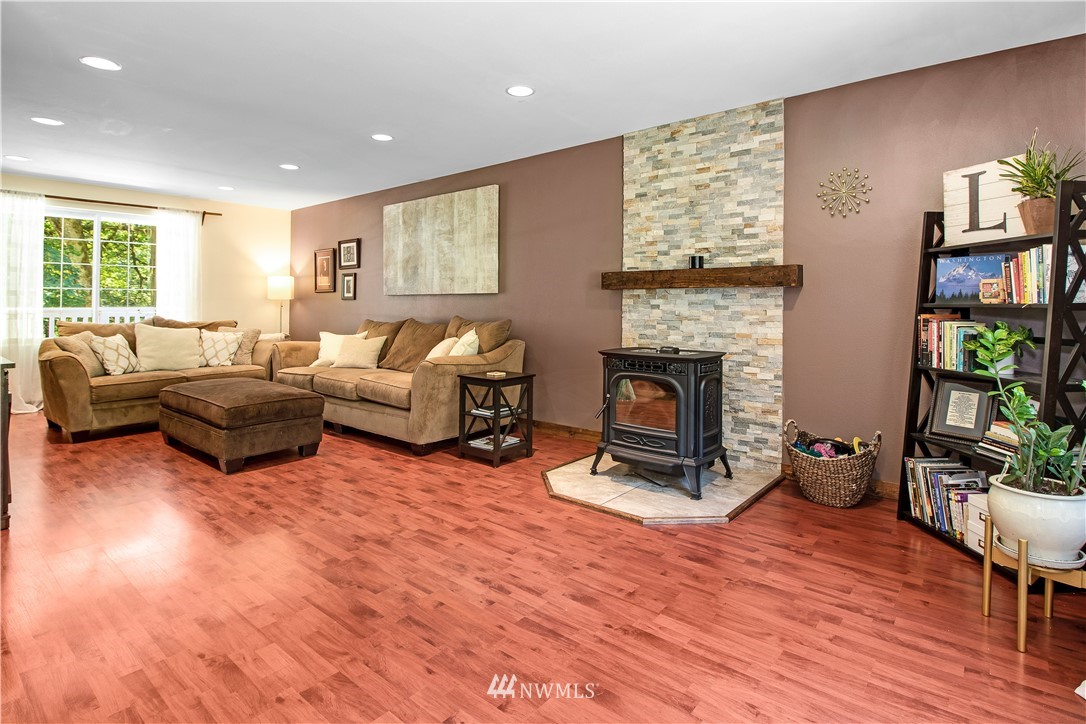 16704 Sargent Road Southwest Rochester, WA 98579 - Photo 8 of 40 a living room with furniture a fireplace and a window