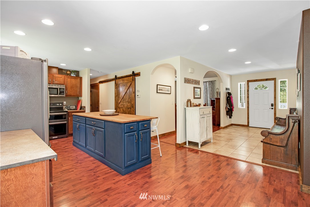 16704 Sargent Road Southwest Rochester, WA 98579 - Photo 10 of 40 a kitchen with stainless steel appliances granite countertop a refrigerator and a stove