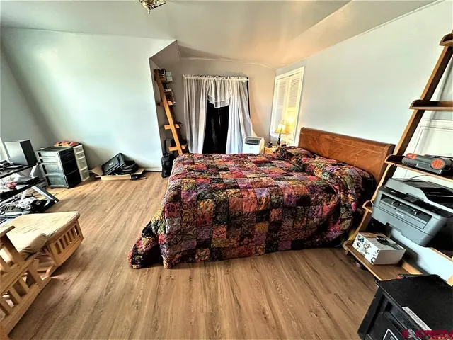 a bedroom with bed and a window