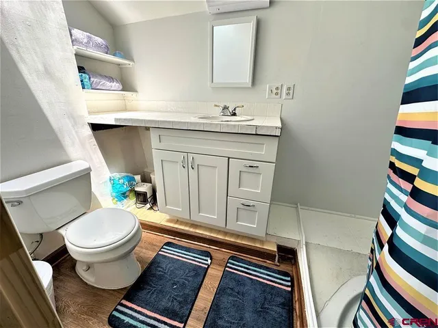 a bathroom with a sink toilet and a mirror