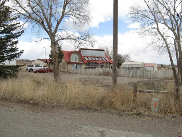 a view of a lake with a bench next to a road