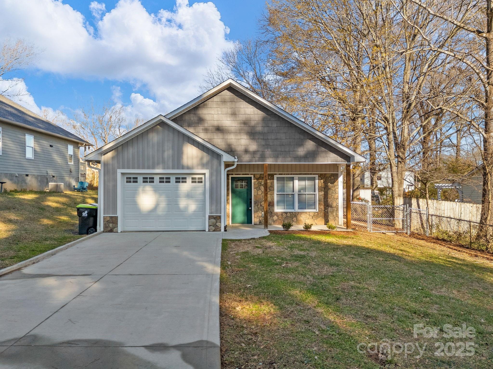 a front view of a house with a yard and outdoor seating