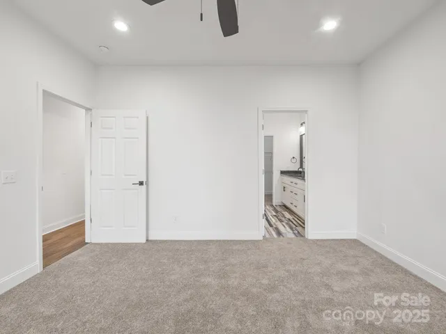 an empty room with sliding door and natural light