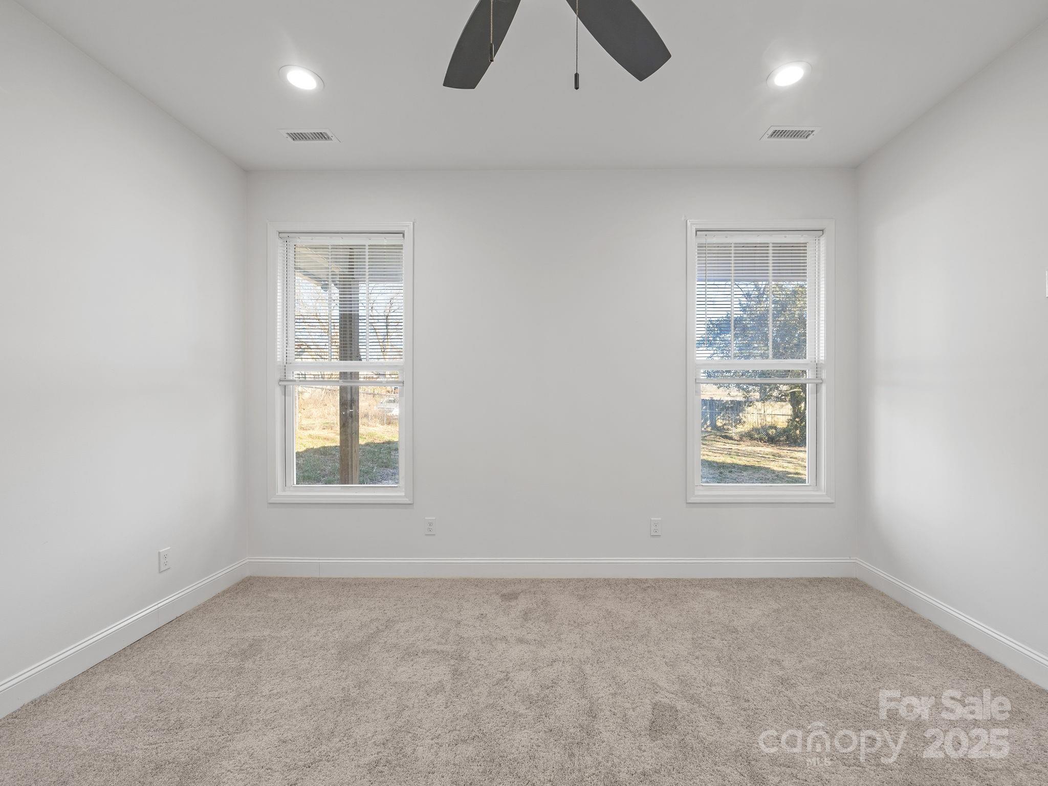 409 South Lyles Avenue Landrum, SC 29356 - Photo 19 of 36 an empty room with windows