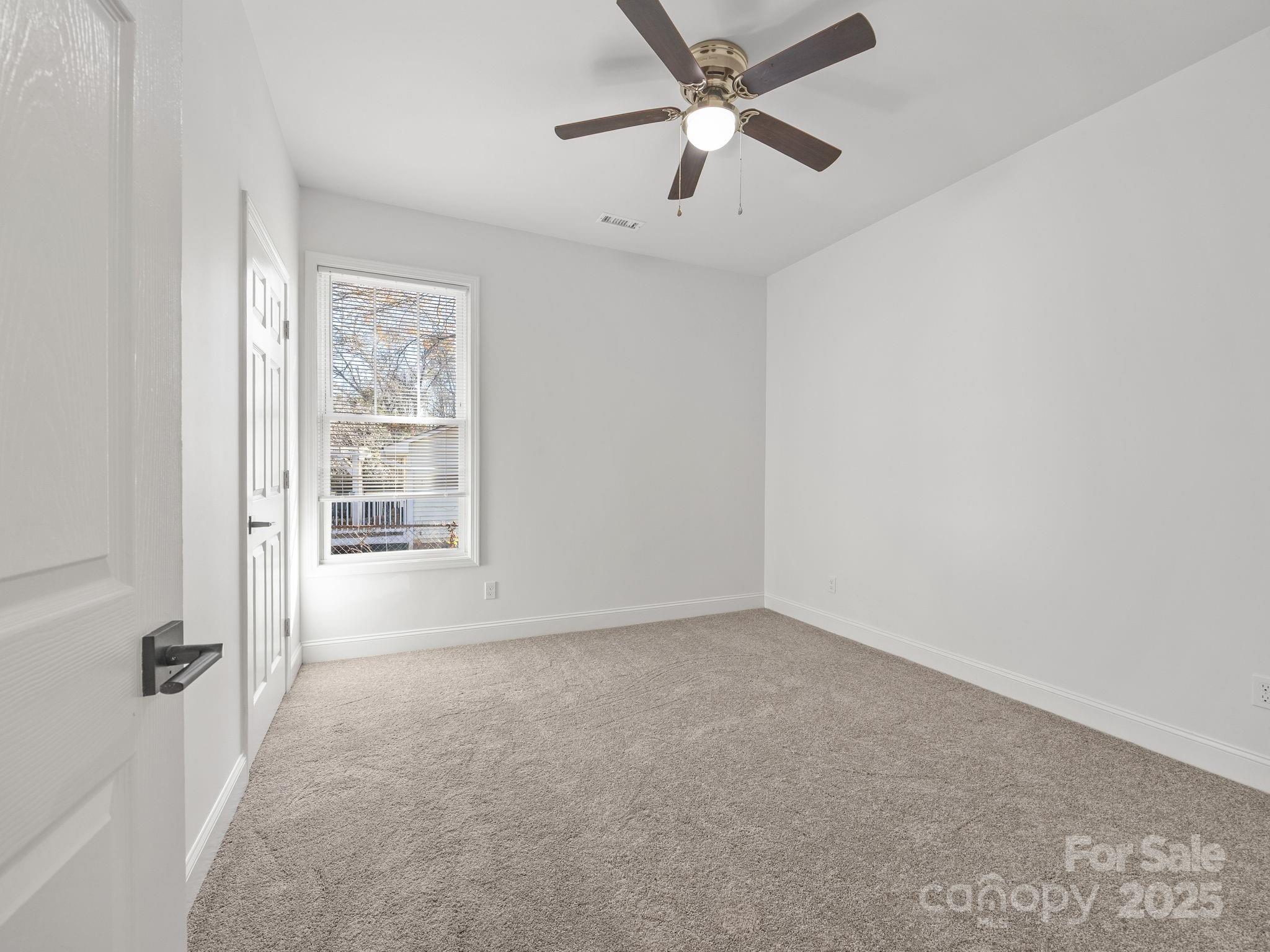 409 South Lyles Avenue Landrum, SC 29356 - Photo 28 of 36 an empty room with windows and fan