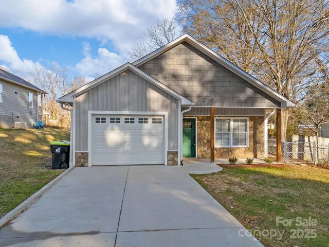 a front view of a house with a yard and outdoor seating