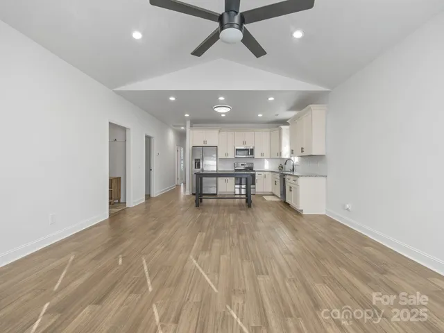 a view of a kitchen with a sink and cabinets