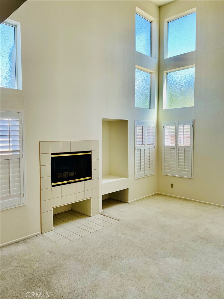 43222 Darby Street Lancaster, CA 93535 - Photo 3 of 9 a view of an empty room with a window and a kitchen