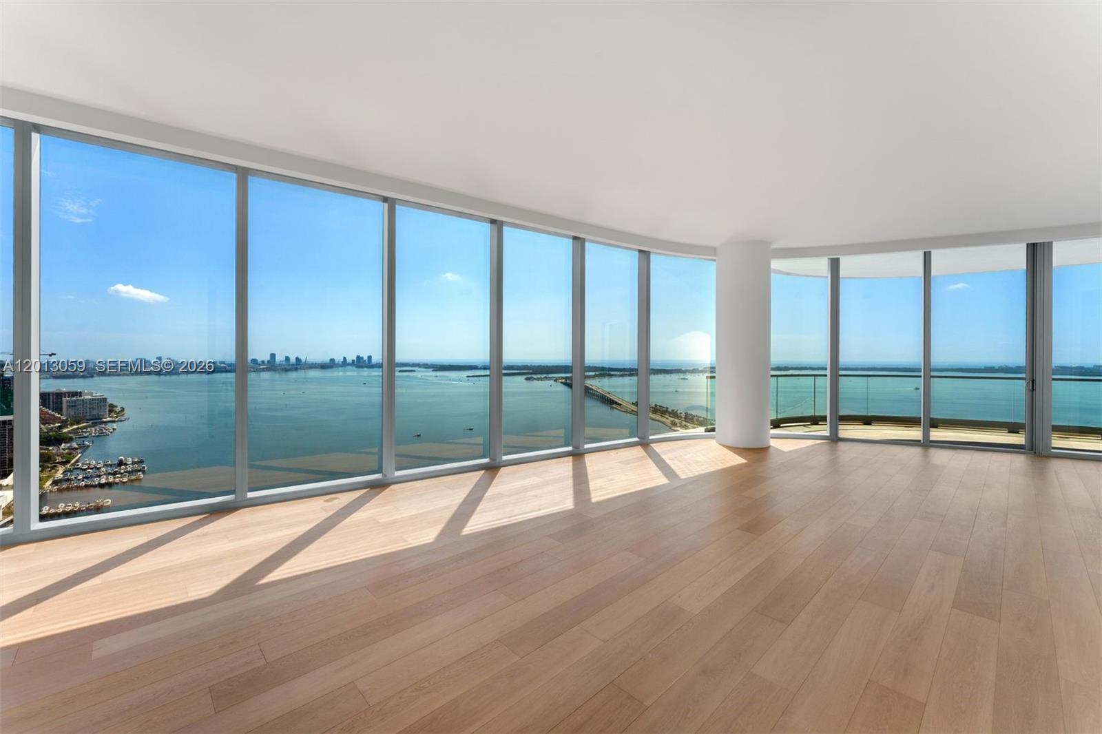 175 Southeast 25th Road, Unit 3601 Miami, FL 33129 - Photo 4 of 27 a view of empty room with wooden floor and floor to ceiling window