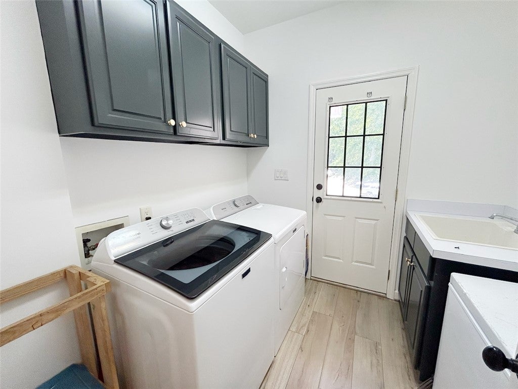 2004 Moores Mill Road Lanett, AL 36863 - Photo 29 of 50 This functional laundry area features ample storage and a convenient utility sink.