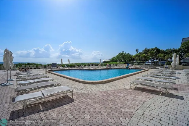 a view of a swimming pool with an outdoor space and seating area