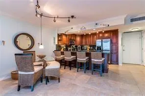a living room with couches a dining table and kitchen view