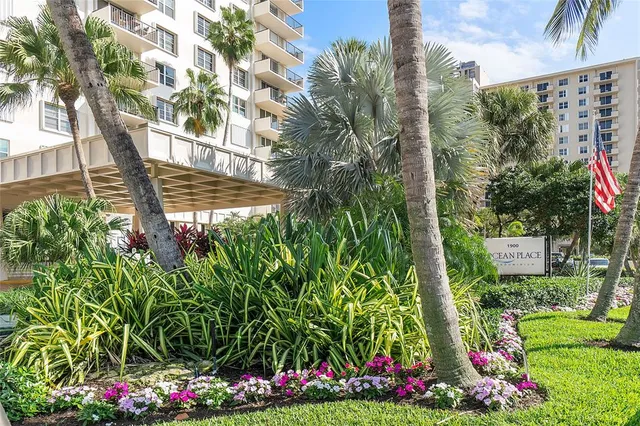 a view of a wooden fence with a flower garden
