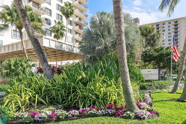 a view of a wooden fence with a flower garden