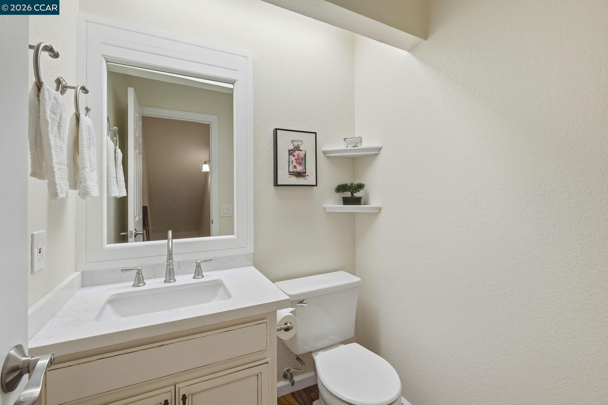 1707 Geary Road Walnut Creek, CA 94597 - Photo 28 of 43 a bathroom with a toilet sink vanity and mirror