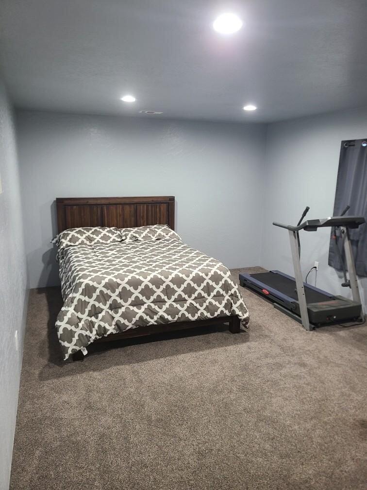 6188 Upton Road Central Point, OR 97502 - Photo 7 of 10 a bed sitting in a room next to a lamp