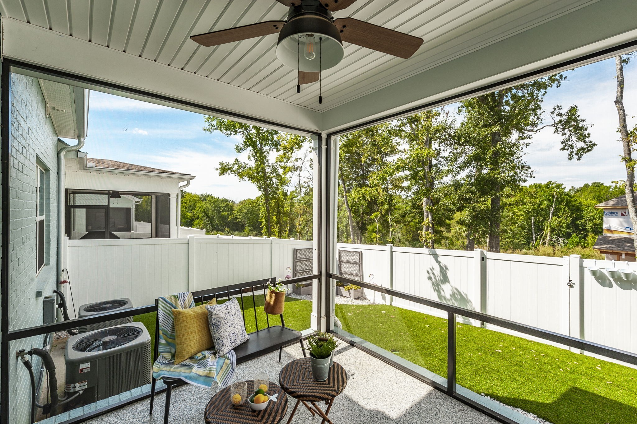 a view of a porch with furniture and a yard