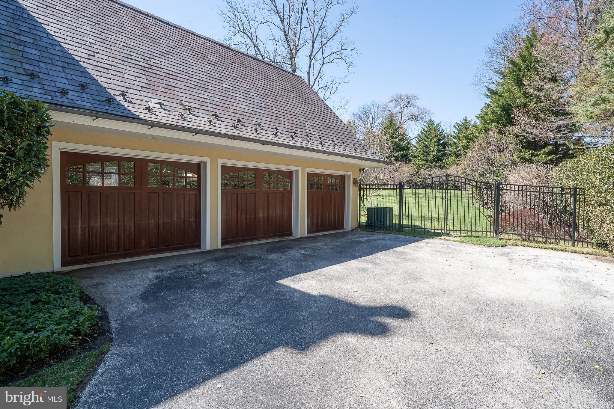 1122 Brynlawn Road Villanova, PA 19085 - Photo 16 of 46 a view of backyard with large trees and wooden fence