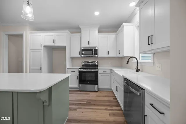 a large kitchen with a table and chairs