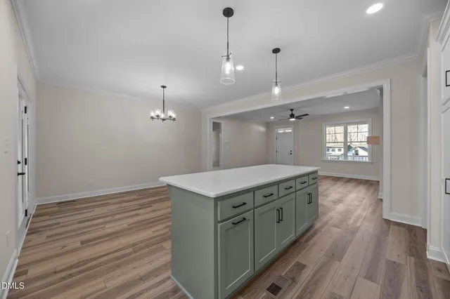 a kitchen with a sink a counter top space stainless steel appliances and cabinets