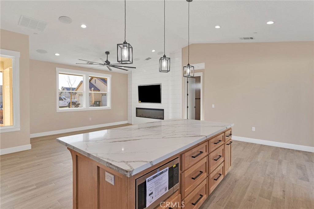 16618 Country Ranch Court Victorville, CA 92395 - Photo 11 of 31 a kitchen with stainless steel appliances granite countertop a kitchen island a stove and a refrigerator
