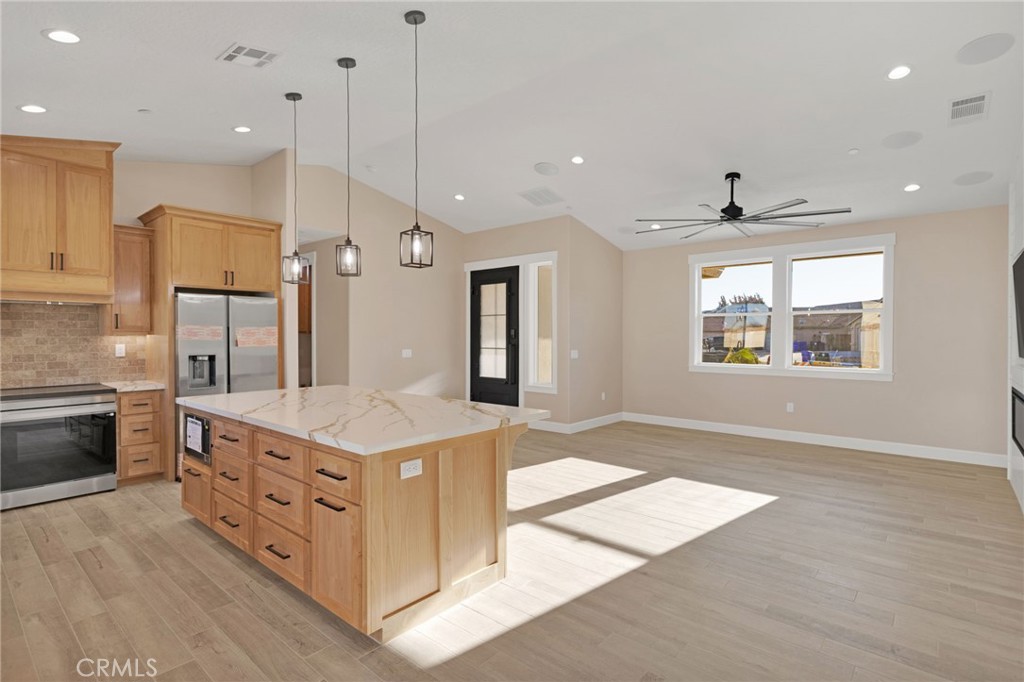 16618 Country Ranch Court Victorville, CA 92395 - Photo 12 of 31 a kitchen with stainless steel appliances granite countertop a sink a stove a refrigerator and a oven