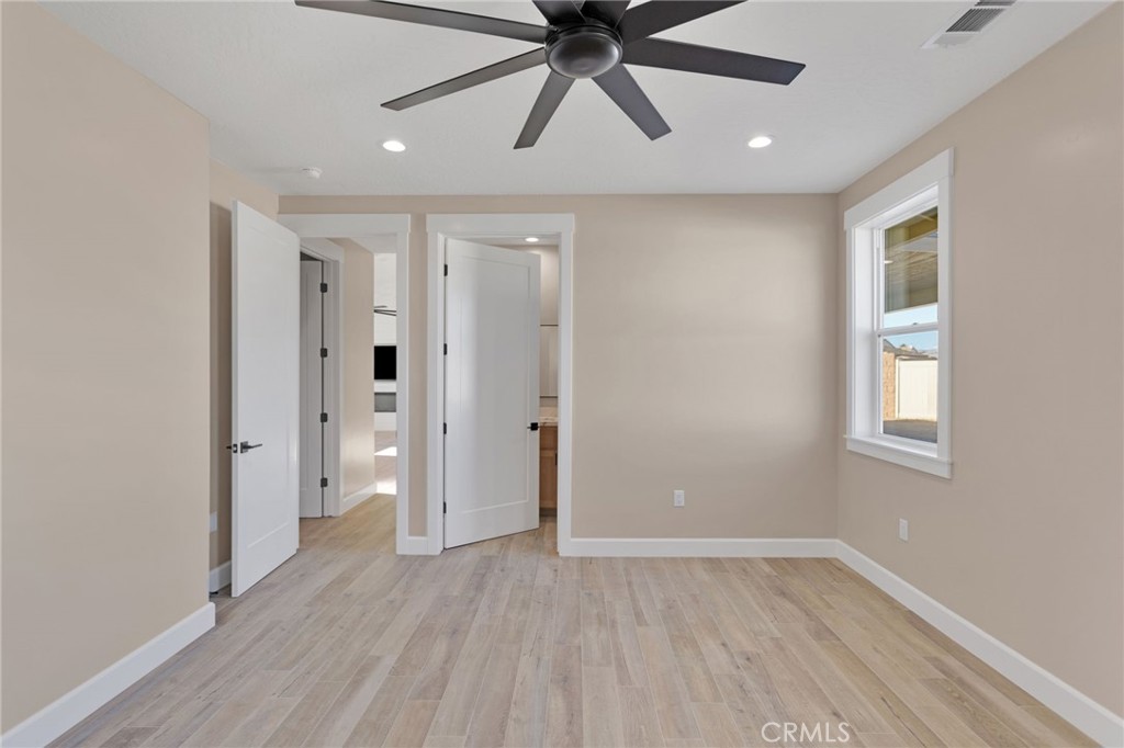 16618 Country Ranch Court Victorville, CA 92395 - Photo 16 of 31 wooden floor in an empty room with a window