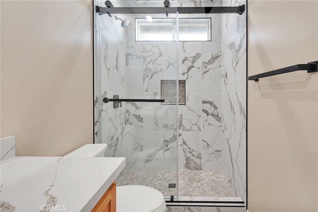 16618 Country Ranch Court Victorville, CA 92395 - Photo 20 of 31 a bathroom with a shower toilet and sink