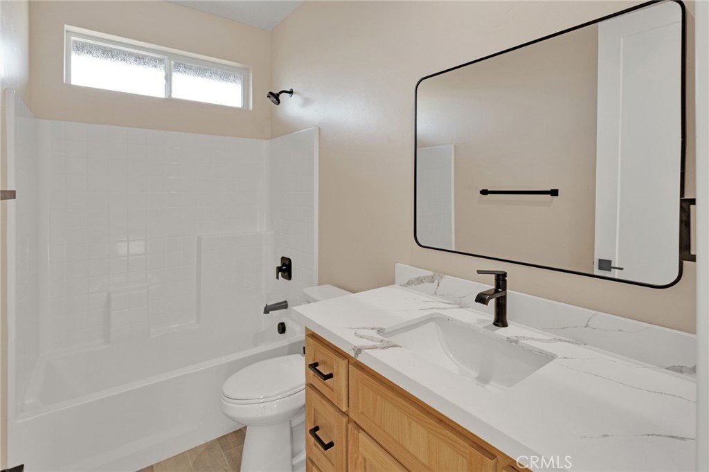 16618 Country Ranch Court Victorville, CA 92395 - Photo 23 of 31 a bathroom with a sink a toilet and a mirror