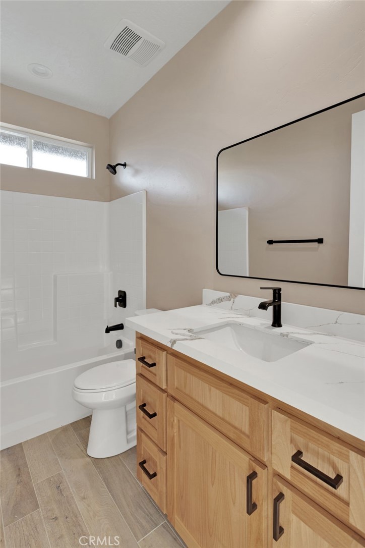 16618 Country Ranch Court Victorville, CA 92395 - Photo 24 of 31 a bathroom with a sink a toilet and a mirror