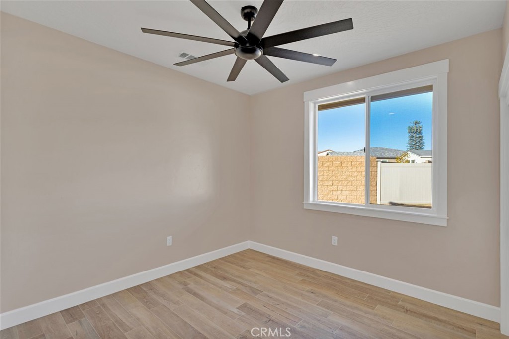 16618 Country Ranch Court Victorville, CA 92395 - Photo 25 of 31 wooden floor in an empty room with a window