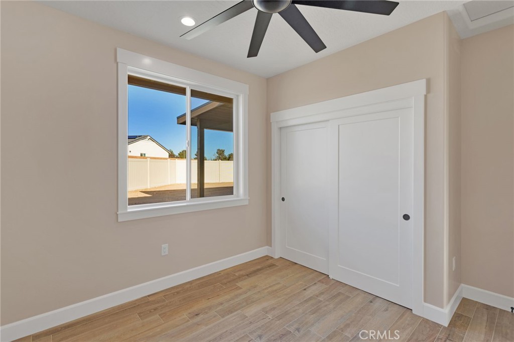 16618 Country Ranch Court Victorville, CA 92395 - Photo 26 of 31 a view of an empty room with wooden floor and a window