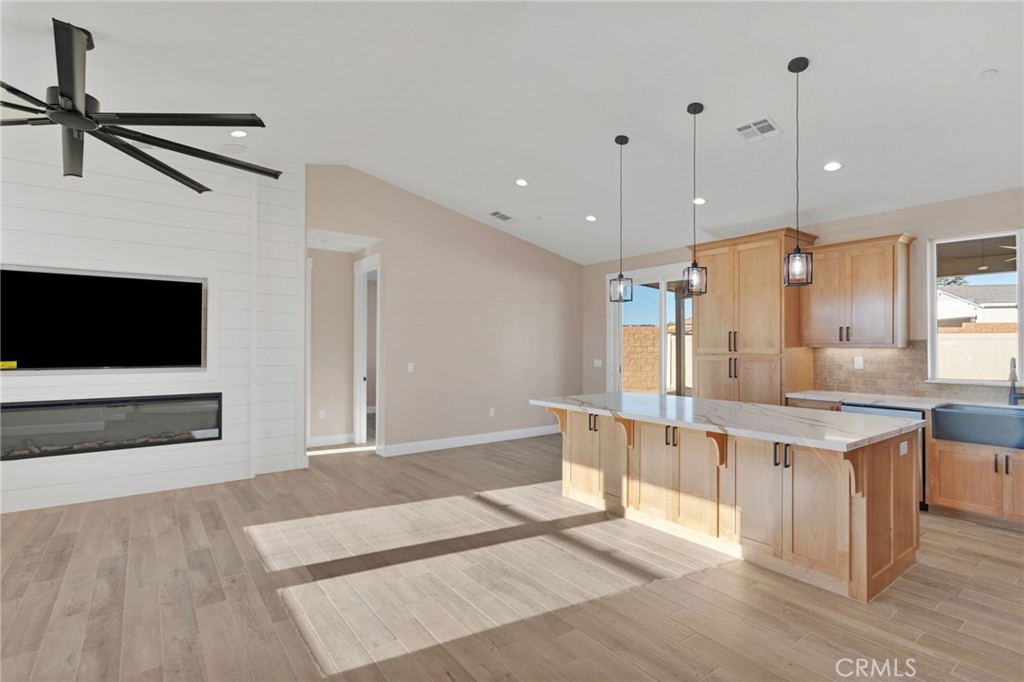 16618 Country Ranch Court Victorville, CA 92395 - Photo 4 of 31 a large white kitchen with a large counter top a sink stainless steel appliances and cabinets