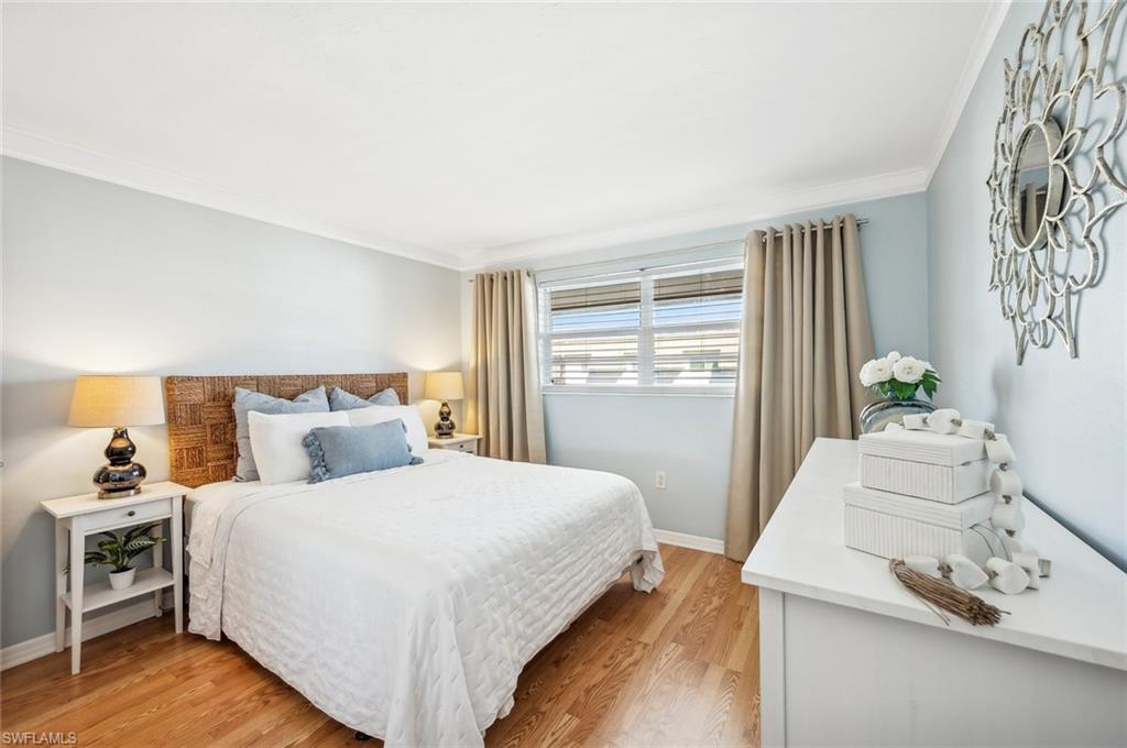 72 7th Street South, Unit 305 Naples, FL 34102 - Photo 12 of 26 a bedroom with a bed and a window