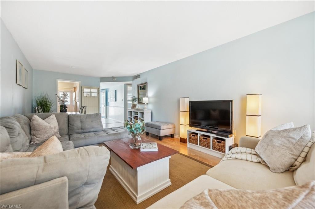 72 7th Street South, Unit 305 Naples, FL 34102 - Photo 14 of 26 a living room with furniture and a flat screen tv