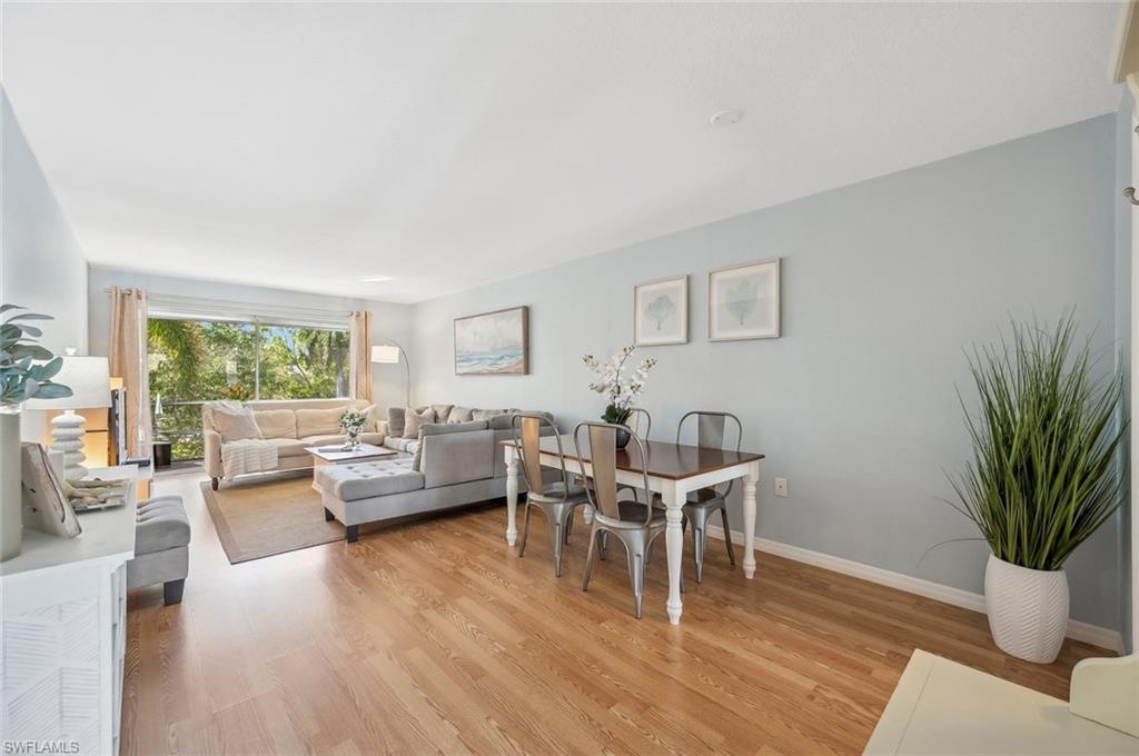 72 7th Street South, Unit 305 Naples, FL 34102 - Photo 2 of 26 a living room with furniture and a potted plant