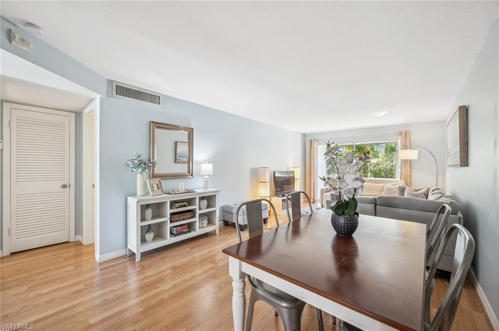 72 7th Street South, Unit 305 Naples, FL 34102 - Photo 8 of 26 a view of a dining room with furniture and a potted plant