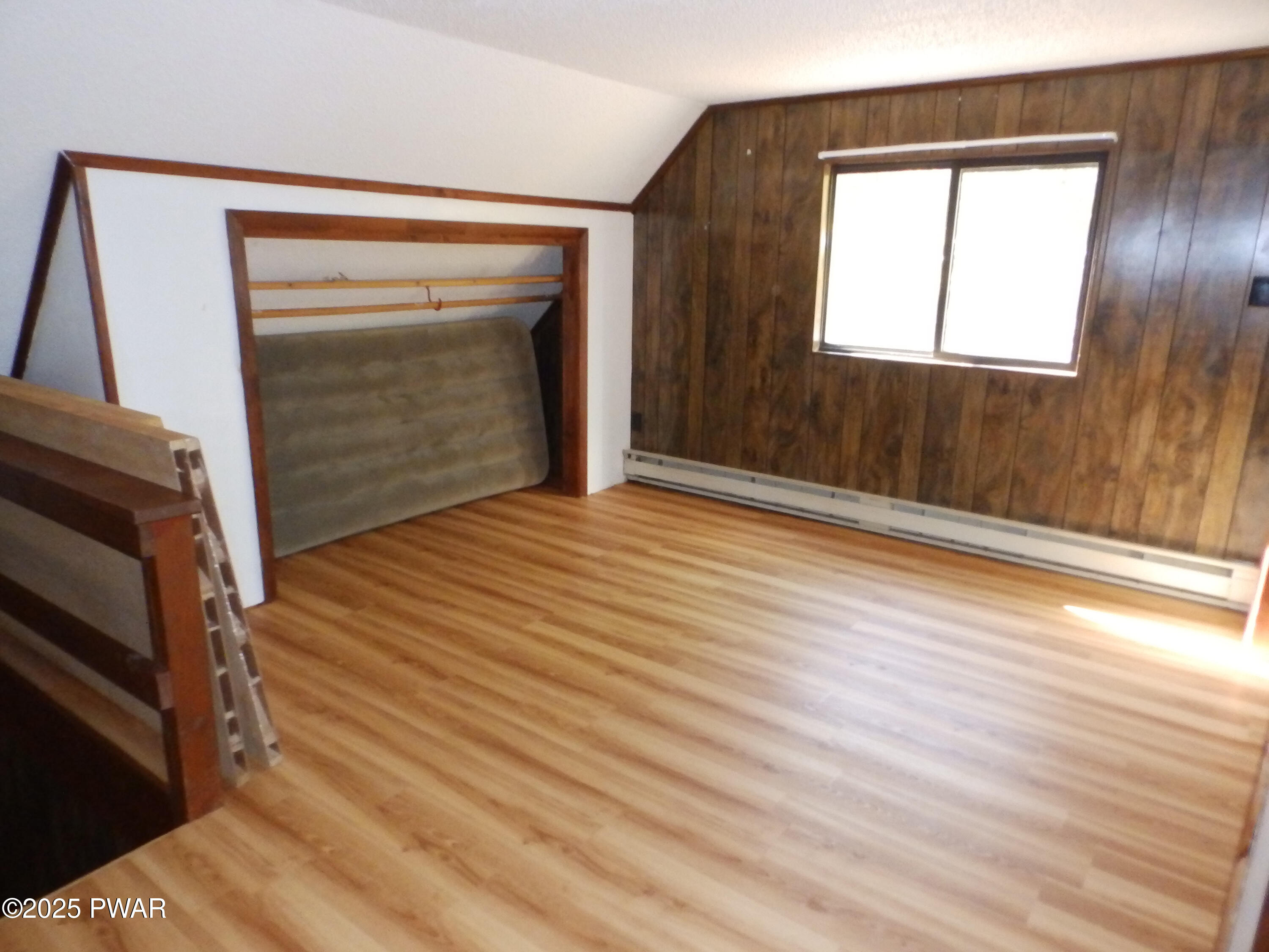 105 Roundhill Road Dingmans Ferry, PA 18328 - Photo 10 of 18 a view of an empty room with wooden floor and a window