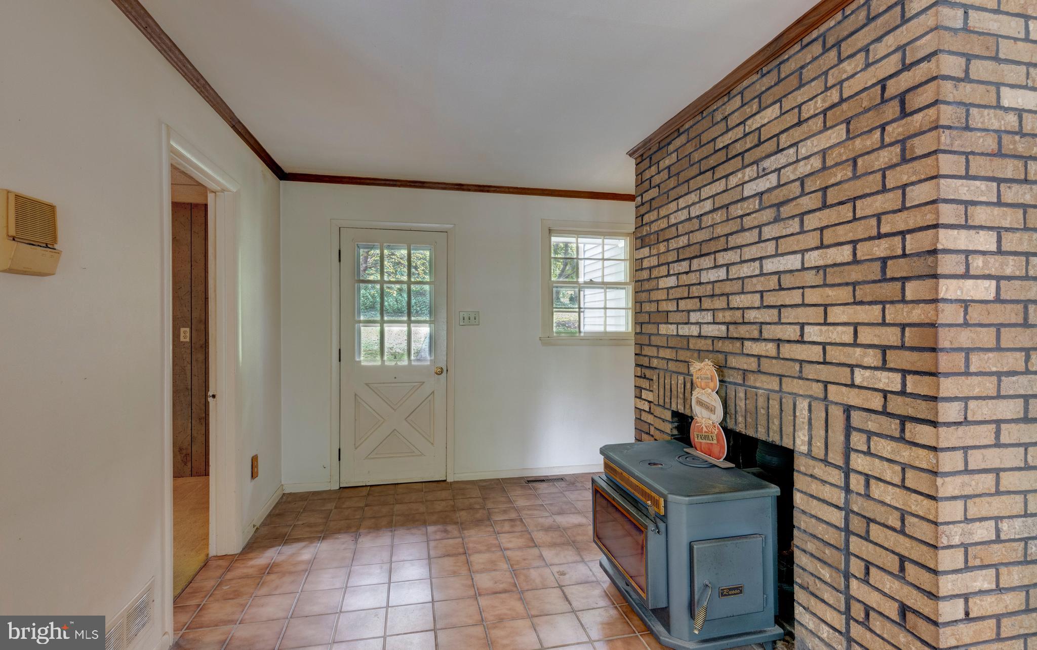 228 Leppo Road Westminster, MD 21158 - Photo 32 of 73 2nd front entrance with tile floor and wood stove