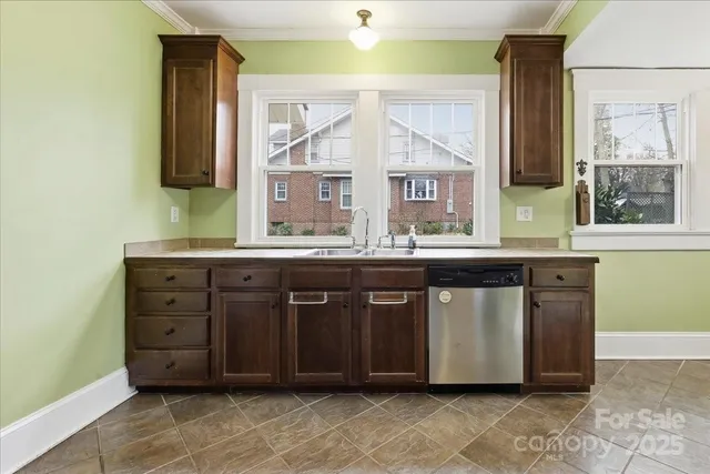 a large kitchen with stainless steel appliances granite countertop a stove a sink and a refrigerator