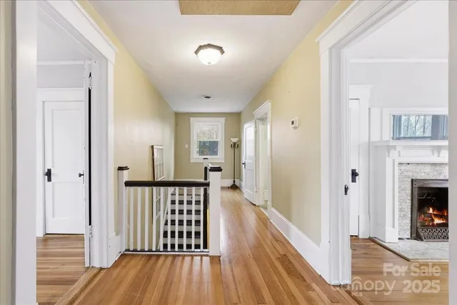 a view of a livingroom with wooden floor and a fireplace