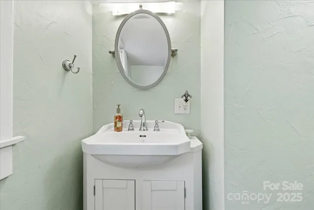 a view of a yard in front of a house with a large tree