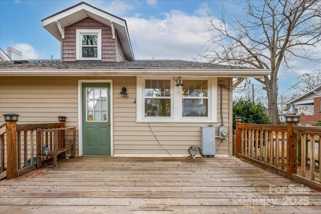 a front view of a house with a garden and yard