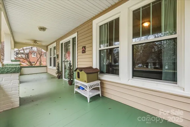 a view of a livingroom with a fireplace wooden floor and a window