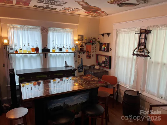 a view of livingroom with hardwood floor and a kitchen