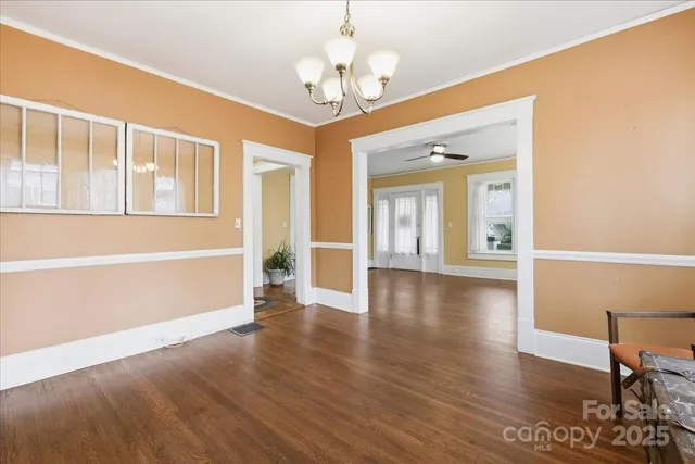 a view of a livingroom with furniture wooden floor and windows