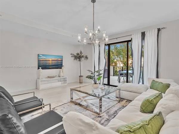 a living room with furniture a chandelier and a chandelier