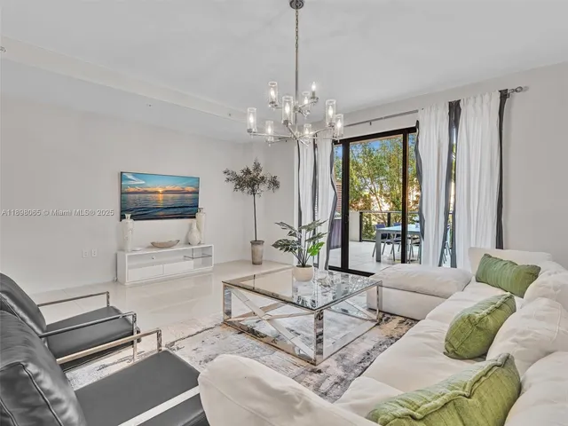 a living room with furniture a chandelier and a chandelier