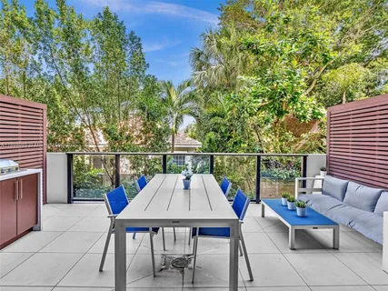 a view of a deck with two chair and a potted plant
